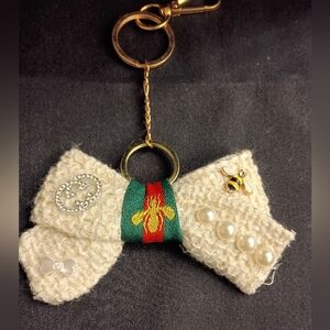 Elegant Cream Bow Keychain with Gold Accents